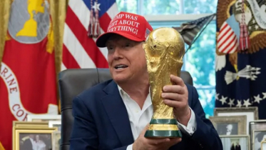 Donald Trump holds the World Cup trophy
